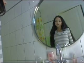 Brunette enchantress movies her shaved twat in the bathroom solo
